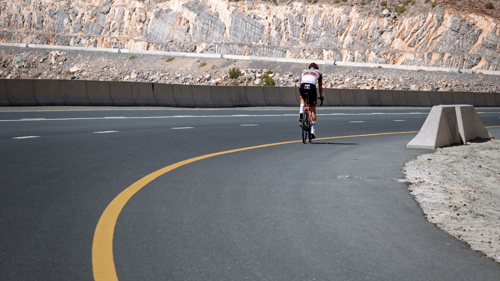 A cyclist climbing a mountain road